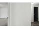 Hallway featuring neutral paint, contrasting trim, and access to additional rooms at 1629 Dartmouth Dr, Holiday, FL 34691