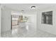 Bright kitchen with white cabinetry, a breakfast bar, and tile flooring throughout at 1629 Dartmouth Dr, Holiday, FL 34691