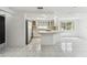 This open-concept kitchen features stainless steel appliances, white cabinets, and a breakfast bar at 1629 Dartmouth Dr, Holiday, FL 34691