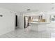 The kitchen features stainless steel appliances, white cabinets, a breakfast bar, and tile flooring at 1629 Dartmouth Dr, Holiday, FL 34691