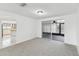 Open floor plan with dining area, neutral carpet, and access to a screened lanai at 1629 Dartmouth Dr, Holiday, FL 34691