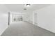 Large living area with neutral carpeting, bright light, and patio access at 1629 Dartmouth Dr, Holiday, FL 34691