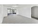Bright living space with new carpeting and sliding glass doors to outdoor space at 1629 Dartmouth Dr, Holiday, FL 34691