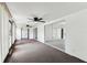 Bright sun room with large windows, ceiling fans, neutral carpet, and access to the outdoors at 1629 Dartmouth Dr, Holiday, FL 34691