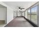 Spacious sunroom with lots of natural light, ceiling fans, and glass doors leading to the outside at 1629 Dartmouth Dr, Holiday, FL 34691