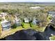 Aerial shot of a home on a lake with a spacious backyard, screened-in pool, and mature landscaping at 16644 Vallely Dr, Tampa, FL 33618