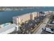 Aerial view of a condo building highlighting the parking lot, community pool, and waterfront proximity at 1847 Shore S Dr # 215, South Pasadena, FL 33707