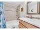 Well-lit bathroom features tiled shower, updated vanity, and decorative accents at 1847 Shore S Dr # 215, South Pasadena, FL 33707