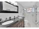 Bathroom featuring a double sink vanity and glass shower enclosure at 1847 Shore S Dr # 215, South Pasadena, FL 33707