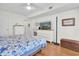 Bedroom featuring wood floors, a dresser, a TV, and a queen-sized bed at 1847 Shore S Dr # 215, South Pasadena, FL 33707