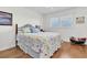 Cozy bedroom featuring hardwood floors, natural light, and beach-themed bedding at 1847 Shore S Dr # 215, South Pasadena, FL 33707