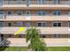 A nice facade with a small palm tree that provides shade near the entrance of the home at 1847 Shore S Dr # 215, South Pasadena, FL 33707