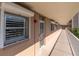 A hallway leading to a unit with roller shutters and a glimpse of the beach area at 1847 Shore S Dr # 215, South Pasadena, FL 33707
