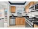 A bright kitchen featuring stainless steel appliances and wood cabinets at 1847 Shore S Dr # 215, South Pasadena, FL 33707