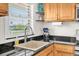 Kitchen sink with window view, light wood cabinets and stainless steel appliances at 1847 Shore S Dr # 215, South Pasadena, FL 33707