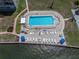 Aerial view of community pool and lounge area overlooking calm waterway at 1847 Shore S Dr # 215, South Pasadena, FL 33707