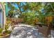 Landscaped back yard featuring a large stone patio and mature shade trees at 211 21St S Ave, St Petersburg, FL 33705