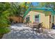 Outdoor patio with various seating arrangements and a wooden fence in a shaded yard at 211 21St S Ave, St Petersburg, FL 33705