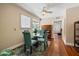 Cozy dining area with a glass table, four teal chairs, and a ceiling fan at 211 21St S Ave, St Petersburg, FL 33705