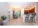 Bright dining area with a glass-top table set and adjacent breakfast bar and opens to the kitchen at 2831 Santego Bay Ct, Brandon, FL 33511