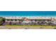 Stunning aerial view of beachfront condos with a pool, parking, and access to the beautiful ocean at 3100 Gulf Blvd # 134, Belleair Beach, FL 33786