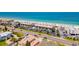 An aerial view showcases a condo building by the ocean with parking and easy beach access at 3100 Gulf Blvd # 134, Belleair Beach, FL 33786
