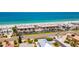 Aerial view of beach condos with a pool, parking, and convenient beach access at 3100 Gulf Blvd # 134, Belleair Beach, FL 33786