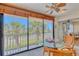 Glass enclosed balcony with table offers views of the surrounding area at 3100 Gulf Blvd # 134, Belleair Beach, FL 33786