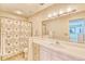 Well-lit bathroom featuring a vanity with a sink and a shower with a curtain at 3100 Gulf Blvd # 134, Belleair Beach, FL 33786