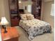 Cozy bedroom featuring a queen bed with custom bedding, built-in shelves, and an inviting, peaceful atmosphere at 3100 Gulf Blvd # 134, Belleair Beach, FL 33786