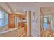 Kitchen entrance features stainless steel refrigerator, wood cabinets, and decor at 3100 Gulf Blvd # 134, Belleair Beach, FL 33786