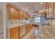 Bright kitchen featuring wood cabinets, stainless steel appliances and granite countertops at 3100 Gulf Blvd # 134, Belleair Beach, FL 33786