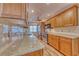 Bright kitchen featuring wood cabinets, stainless steel appliances and granite countertops at 3100 Gulf Blvd # 134, Belleair Beach, FL 33786