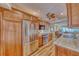 Kitchen featuring stainless steel refrigerator, granite counters and beautiful wood cabinetry at 3100 Gulf Blvd # 134, Belleair Beach, FL 33786