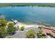 Aerial view showcases beautiful waterfront on a clear, sunny day with parking, covered pavilions, and a pier at 3114 Samara Dr, Tampa, FL 33618