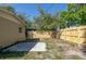 Spacious backyard with new fence, simple concrete patio and a view of the home's exterior at 3235 6Th S Ave, St Petersburg, FL 33701