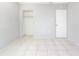 Spacious bedroom with closet and door leading out, featuring neutral paint and tiled floors at 3235 6Th S Ave, St Petersburg, FL 33701