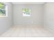 Bright bedroom with dual windows and neutral walls, ready for personalization at 3235 6Th S Ave, St Petersburg, FL 33701