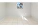 Sun-filled bedroom with neutral walls, tile flooring and a window with outdoor views at 3235 6Th S Ave, St Petersburg, FL 33701