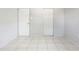 Neutral bedroom with white door and accordion closet door complemented by tile flooring at 3235 6Th S Ave, St Petersburg, FL 33701