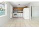 Bright kitchen with white appliances and wooden cabinets, with a view to an adjacent room at 3235 6Th S Ave, St Petersburg, FL 33701