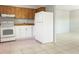 Functional kitchen featuring white appliances and wood cabinetry, providing ample storage at 3235 6Th S Ave, St Petersburg, FL 33701