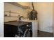 Functional laundry room with washer, dryer, shelving, and water heater at 3235 6Th S Ave, St Petersburg, FL 33701