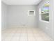Cozy living room with natural light, showcasing tile flooring and simple, neutral decor at 3235 6Th S Ave, St Petersburg, FL 33701