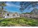Spacious backyard features a well-maintained lawn, a privacy fence, and an inviting patio area for outdoor entertaining at 3316 W Ballast Point Blvd, Tampa, FL 33611