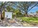 Spacious backyard featuring a fire pit, shed, and seating area at 3316 W Ballast Point Blvd, Tampa, FL 33611