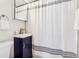 Bathroom showcasing a navy vanity and a white shower curtain at 3316 W Ballast Point Blvd, Tampa, FL 33611
