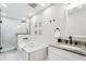 Bright bathroom featuring a white vanity, soaking tub, and glass-enclosed shower at 3316 W Ballast Point Blvd, Tampa, FL 33611