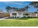 Charming single-story home featuring a well-manicured lawn, a carport and lovely landscaping at 3316 W Ballast Point Blvd, Tampa, FL 33611