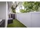 Side yard with artificial grass, shed for storage, and privacy fence, offering practical outdoor space at 3405 W Cherry St, Tampa, FL 33607